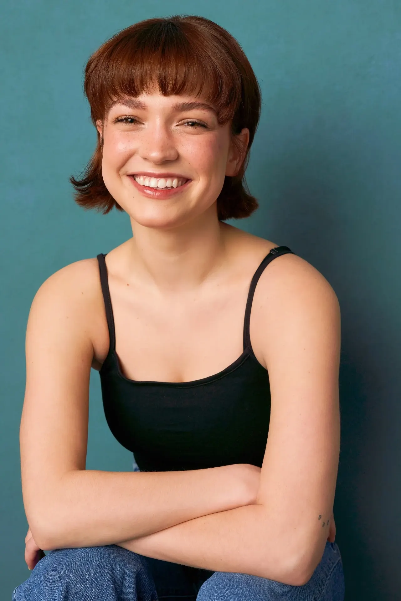 Smiling actor with red hair photographed on a teal backdrop in our Downtown Atlanta studio